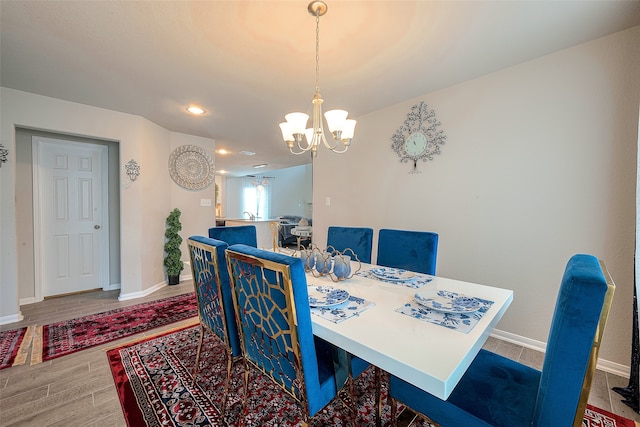 dining room featuring wood-type flooring and a chandelier