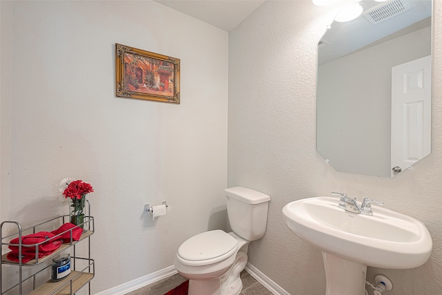 bathroom with toilet and sink