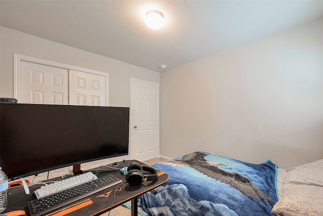 carpeted bedroom featuring a textured ceiling and a closet