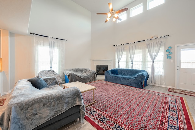 living room with high vaulted ceiling and ceiling fan