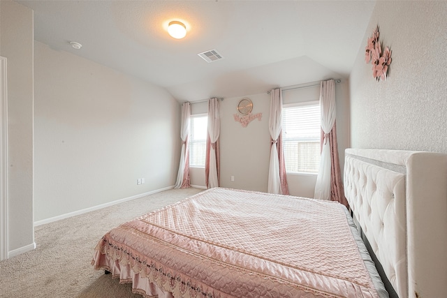 carpeted bedroom featuring vaulted ceiling