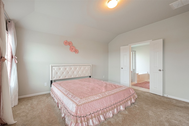 bedroom featuring light colored carpet and vaulted ceiling