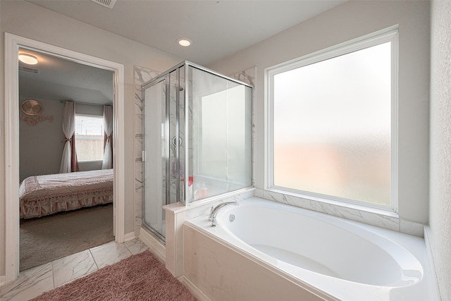 bathroom featuring separate shower and tub