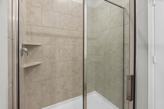 bathroom featuring a shower with shower door