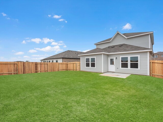 back of property featuring a yard and a patio