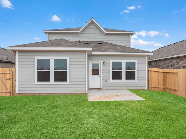 back of property featuring a patio area and a yard