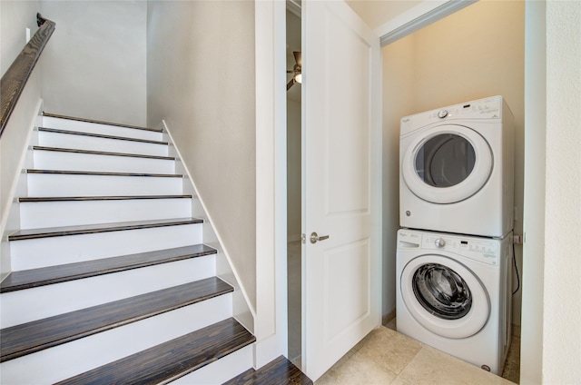 washroom featuring stacked washer and dryer, laundry area, and tile patterned floors