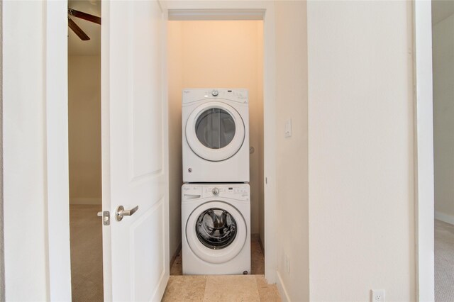 laundry area with stacked washer and clothes dryer, ceiling fan, and laundry area