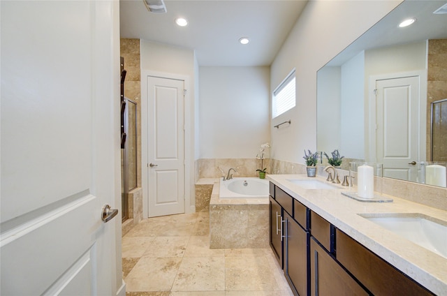 full bathroom with double vanity, a stall shower, a sink, and a bath