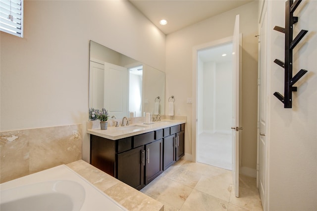 bathroom featuring tile patterned floors, a sink, a bathing tub, and double vanity