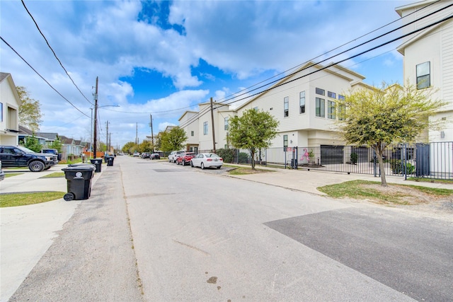 view of road with street lighting, sidewalks, and a residential view