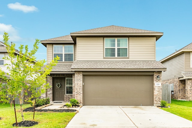 view of front of property with a garage and a front lawn