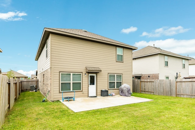 back of property featuring central air condition unit, a lawn, and a patio