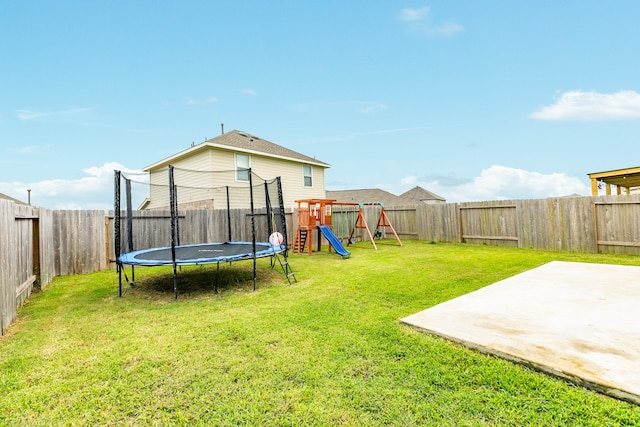 view of yard with a trampoline, a playground, and a patio