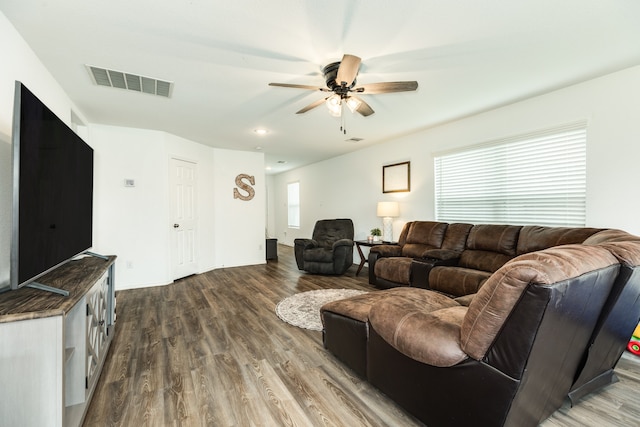 living room featuring hardwood / wood-style floors and ceiling fan