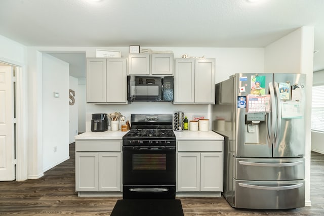 kitchen with gray cabinets, black appliances, and dark hardwood / wood-style flooring