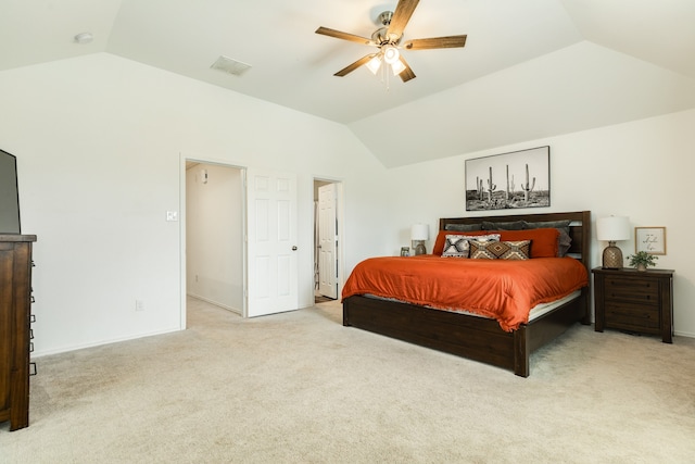 bedroom with lofted ceiling, ceiling fan, and light carpet