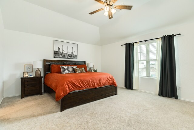 carpeted bedroom featuring lofted ceiling and ceiling fan