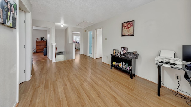 interior space featuring light hardwood / wood-style floors and a textured ceiling