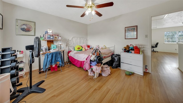 bedroom with light hardwood / wood-style flooring and ceiling fan