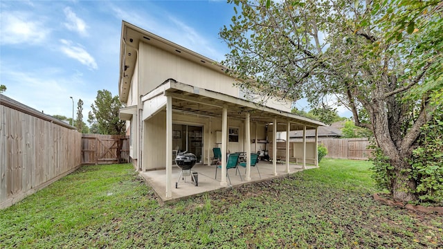 back of house featuring a yard and a patio