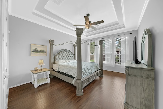 bedroom with ceiling fan, dark hardwood / wood-style floors, a raised ceiling, and crown molding