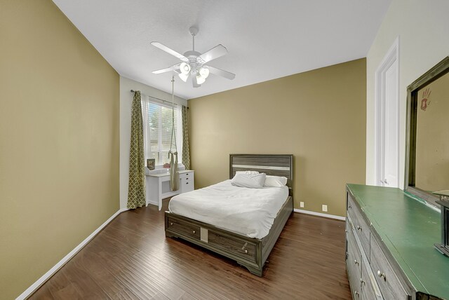 bedroom with ceiling fan and dark hardwood / wood-style flooring