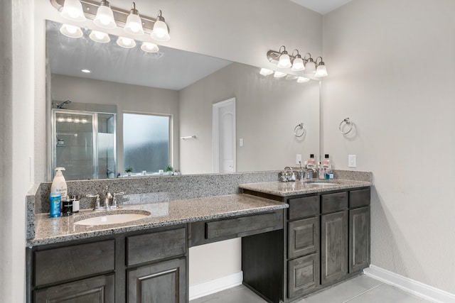 bathroom with vanity, a shower with shower door, and tile patterned flooring