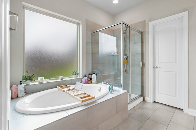 bathroom featuring tile patterned flooring and shower with separate bathtub