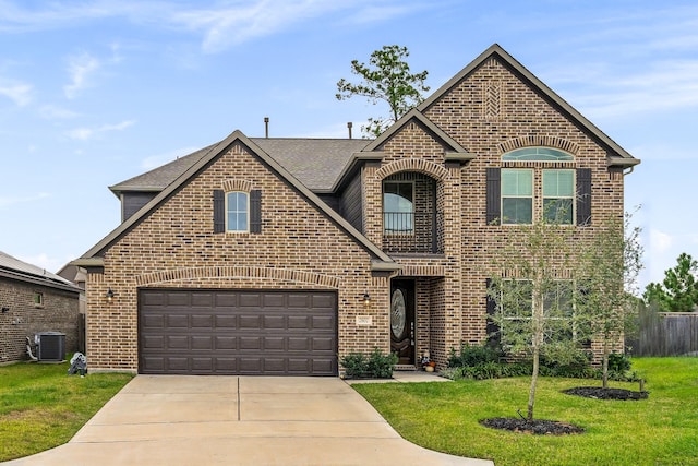 front facade with a garage, a front lawn, and central AC