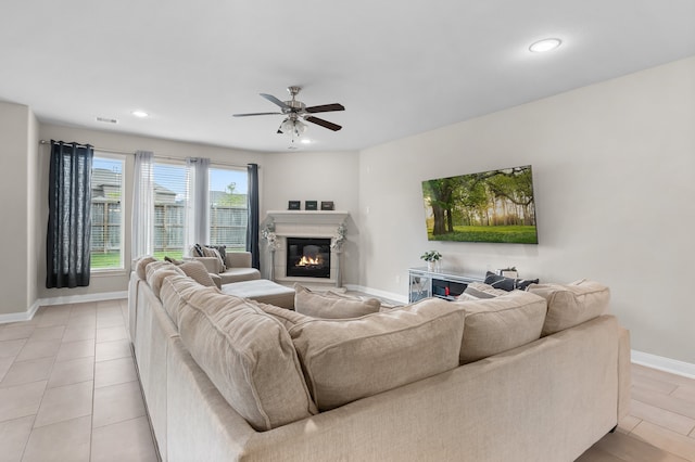 tiled living room featuring ceiling fan