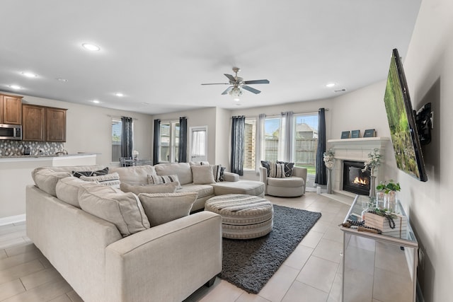 living room with light tile patterned floors and ceiling fan