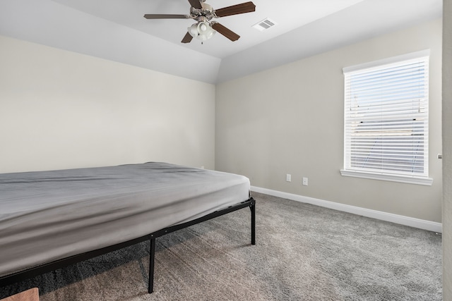 carpeted bedroom featuring lofted ceiling and ceiling fan