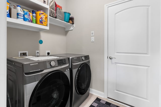 clothes washing area featuring independent washer and dryer and light tile patterned floors