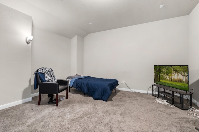 bedroom with lofted ceiling and light carpet