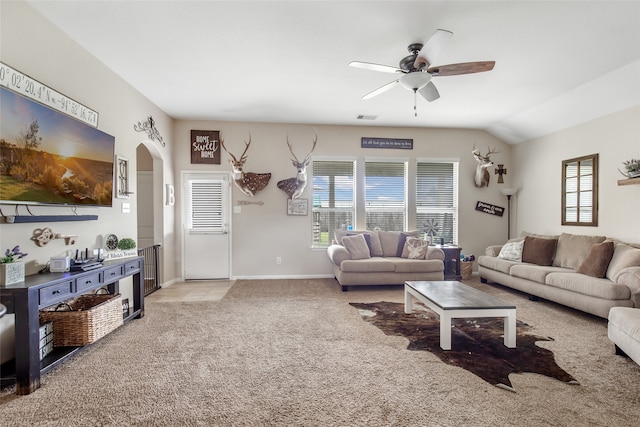 carpeted living room with ceiling fan and lofted ceiling