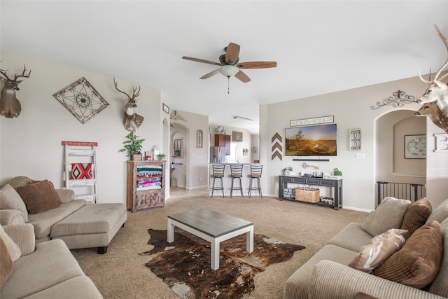 carpeted living room with ceiling fan