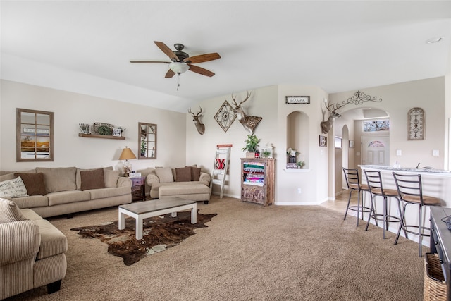 living room featuring carpet flooring and ceiling fan