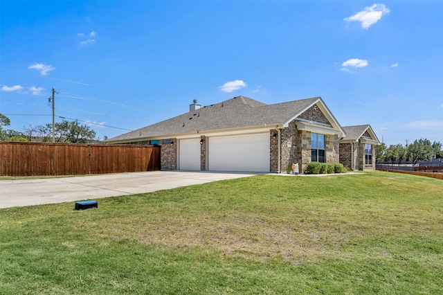 ranch-style house with a garage and a front lawn