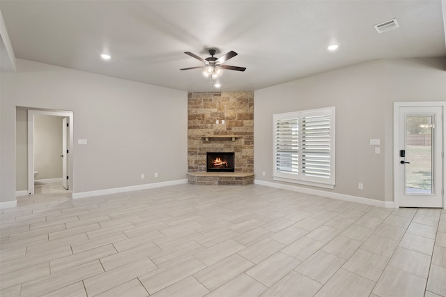 unfurnished living room with ceiling fan and a fireplace