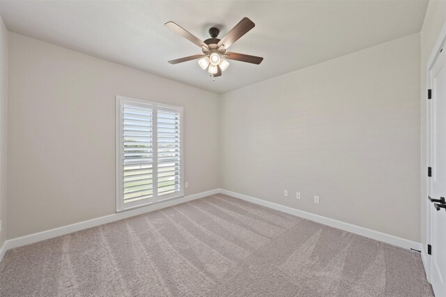 unfurnished room featuring ceiling fan and light carpet