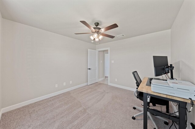 carpeted office featuring ceiling fan