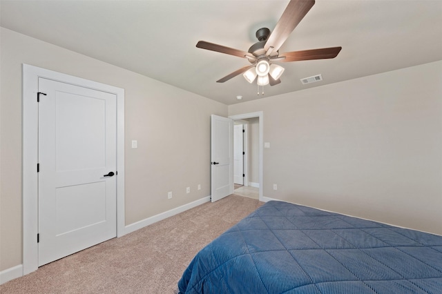 bedroom with baseboards, visible vents, ceiling fan, and light colored carpet