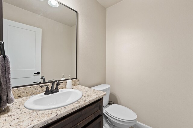 bathroom with toilet and vanity