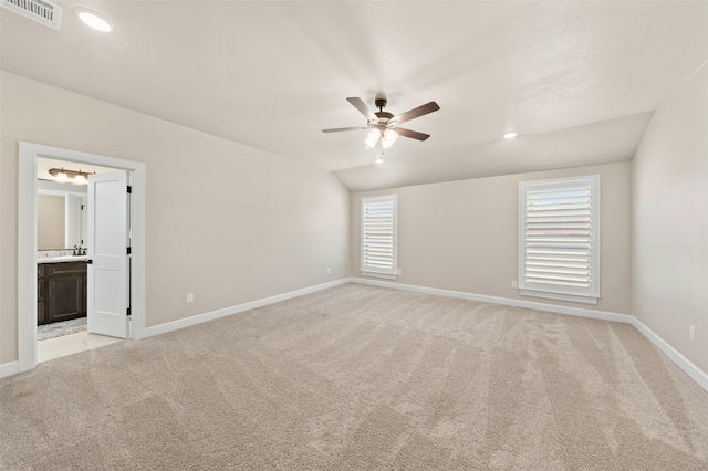 unfurnished room featuring ceiling fan, light carpet, and vaulted ceiling