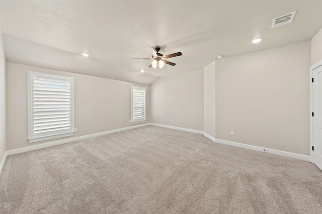 empty room featuring ceiling fan, light carpet, and a healthy amount of sunlight