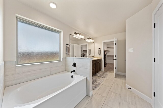 bathroom with vanity, a bathtub, and tile patterned floors