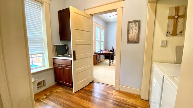 interior space with hardwood / wood-style flooring and washing machine and dryer