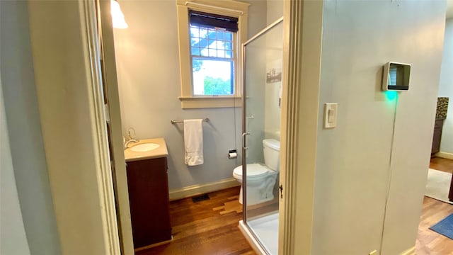 bathroom featuring hardwood / wood-style floors, vanity, and an enclosed shower