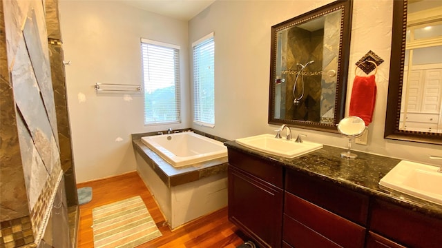 bathroom with separate shower and tub, vanity, and wood-type flooring